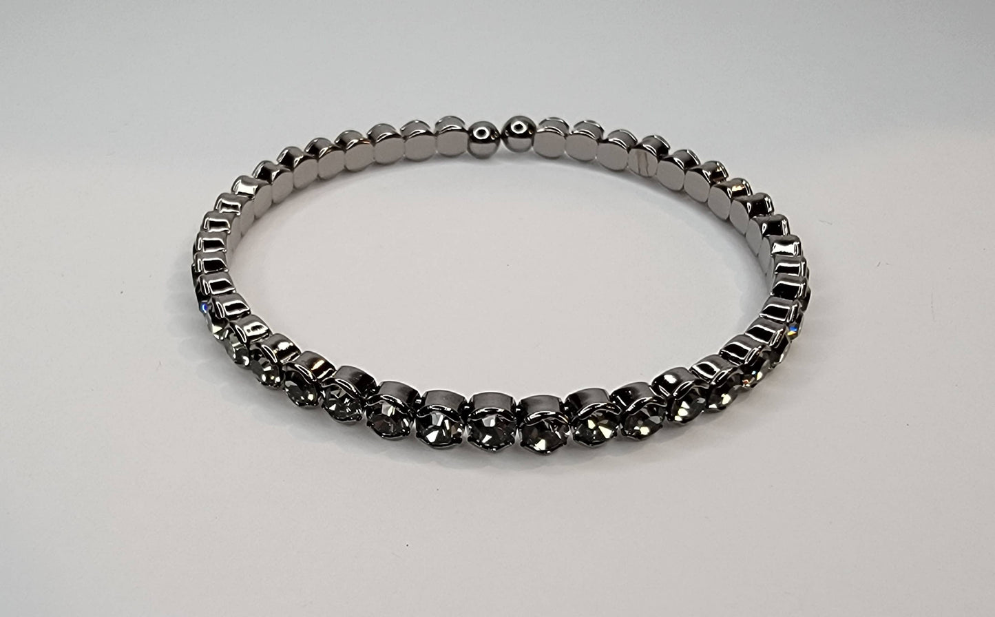 RHINESTONE STACKABLE DARK METAL BRACELET.